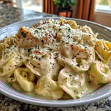 A plate of creamy cheese tortellini alfredo.